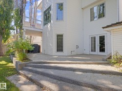 Back of property featuring french doors, a patio, and a balcony - 