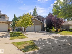 Traditional home with concrete driveway, brick siding, and a front lawn - 