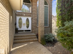 Doorway to property with brick siding, a gate, and french doors - 