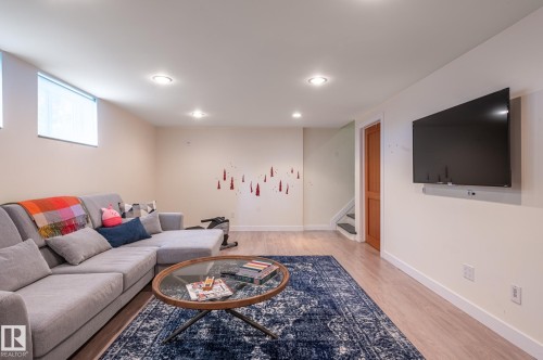 Finished lower level featuring recessed lighting, light wood-finish flooring, and light-toned walls - 11634 74 Avenue Nw, Edmonton, AB 