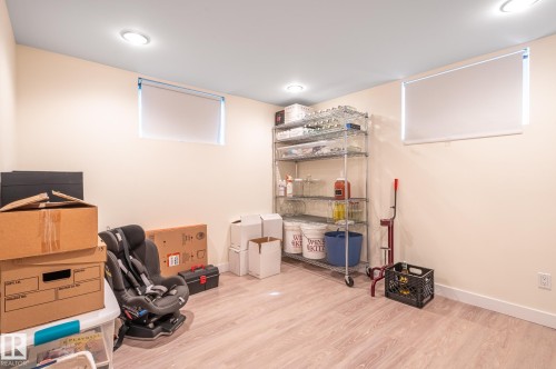Finished basement space featuring light wood-finish flooring and recessed lighting - 11634 74 Avenue Nw, Edmonton, AB 