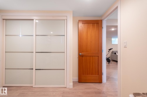 Sliding closet doors with frosted glass panels and light wood-finish frames - 11634 74 Avenue Nw, Edmonton, AB 