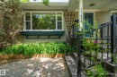 Front exterior with light-colored siding, a blue entry door, and white trim - 11634 74 Avenue Nw, Edmonton, AB 