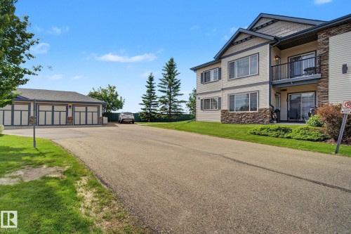 Exterior featuring stone veneer and light-colored siding - 30 2565 Hanna Crescent, Edmonton, AB 