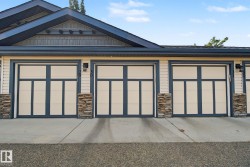 Modern garage doors featuring paneling and transom-style windows - 