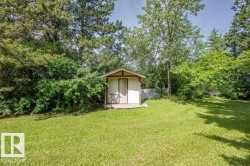 Outdoor shed featuring a wood-finish porch and brown trim accents - 
