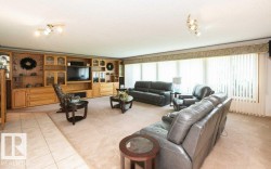 Expansive living area featuring a full-wall built-in media center with wood-finish cabinetry and display cases - 
