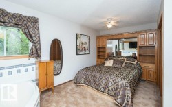 Built-in wood cabinetry surrounding the bed, integrated shelving, and overhead storage - 