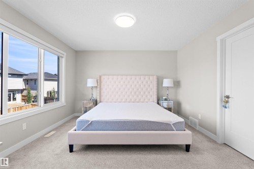 Bedroom with light gray walls and plush gray carpeting - 4673 Alwood Way, Edmonton, AB 