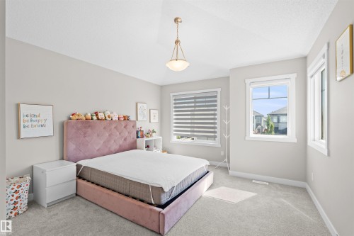 Well-lit room featuring a vaulted ceiling and light gray carpeting - 4673 Alwood Way, Edmonton, AB 