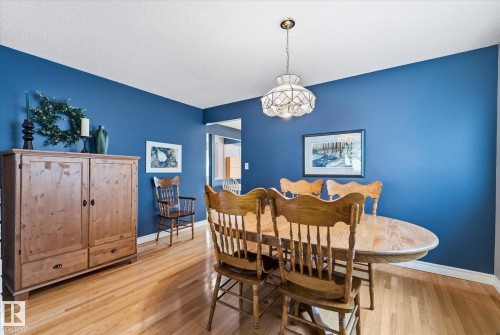 Dining area featuring hardwood flooring and a ceiling-mounted light fixture - 14309 101 Avenue, Edmonton, AB 