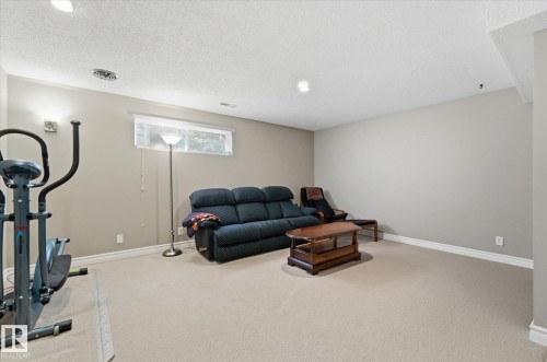 Spacious finished basement featuring light neutral paint, recessed lighting, and a single horizontal window - 14309 101 Avenue, Edmonton, AB 