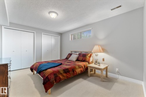 Bedroom featuring light-colored carpet flooring and neutral wall tones - 14309 101 Avenue, Edmonton, AB 