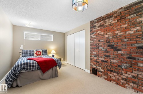 Brick accent wall featuring varied red and brown tones - 14309 101 Avenue, Edmonton, AB 