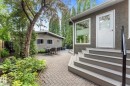 Expansive paver patio with a separate detached structure, mature trees, and established landscaping - 14309 101 Avenue, Edmonton, AB 