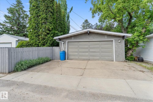 Detached garage with a gray paneled door and stucco exterior - 14309 101 Avenue, Edmonton, AB 