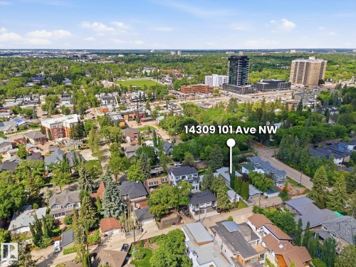 Aerial perspective showcasing a residential neighborhood with varied housing styles and mature tree cover - 14309 101 Avenue, Edmonton, AB 
