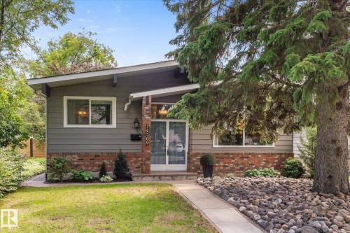 Ranch-style exterior with gray siding and red brick accents - 14309 101 Avenue, Edmonton, AB 