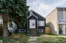 Property exterior featuring a dark stucco finish and white trim - 10035 81 Avenue Nw, Edmonton, AB  - Outdoor 