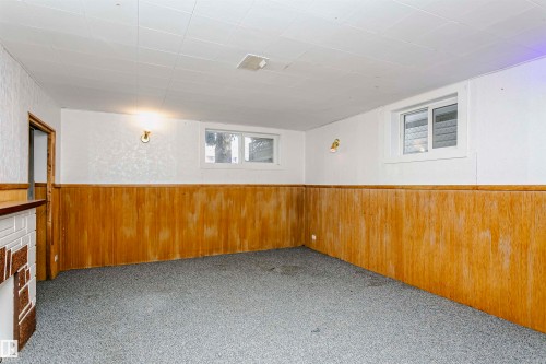 Finished room featuring wood-panel wainscoting, white walls, and a dropped ceiling with recessed lighting - 10035 81 Avenue Nw, Edmonton, AB - Indoor Photo Showing Other Room