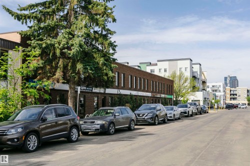 Streetscape featuring a multi-story brick building with commercial storefronts and upper-level windows - 10035 81 Avenue Nw, Edmonton, AB - Outdoor