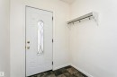 Entryway featuring a white door with decorative glass insert, brass hardware, and contrasting dark flooring - 10035 81 Avenue Nw, Edmonton, AB  - Indoor 