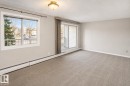 Neutral paint palette with wall-to-wall carpeting - #223 5125 Riverbend Rd Nw, Edmonton, AB  - Indoor Photo Showing Other Room 