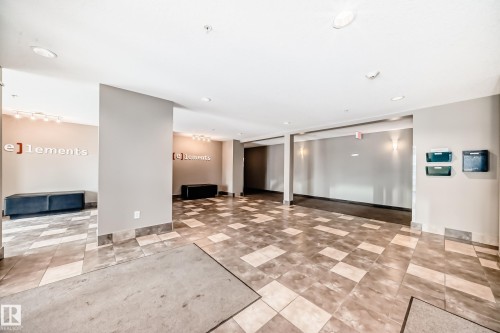 Entryway featuring checkered floor tiling, recessed ceiling lighting, and wall-mounted sconces - 311 142 Ebbers Boulevard, Edmonton, AB 
