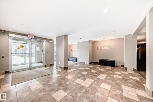 Lobby entry featuring glass automatic doors, recessed lighting, and patterned tile flooring - 311 142 Ebbers Boulevard, Edmonton, AB 