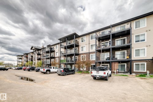 Multi-story building exterior featuring a mix of brown brick and beige siding - 311 142 Ebbers Boulevard, Edmonton, AB 