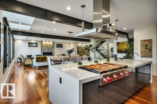 Gourmet kitchen island with an integrated cooktop and stainless steel hood - 8914 120 Street, Edmonton, AB 