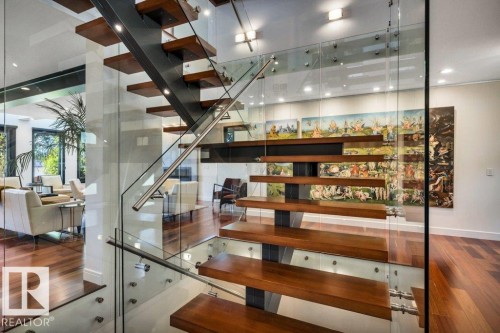 Floating staircase with wood-finish treads and glass railings - 8914 120 Street, Edmonton, AB 