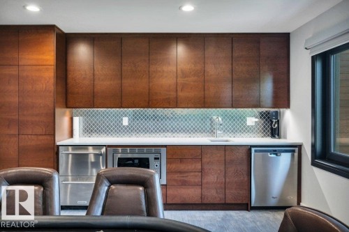 Wet bar featuring dark wood-finish cabinetry, a white countertop, and a diamond-patterned tile backsplash - 8914 120 Street, Edmonton, AB 