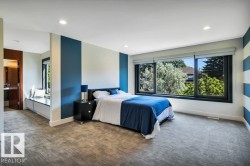 Spacious room featuring multiple windows with tree canopy scenery, recessed lighting, and soft grey textured carpeting - 