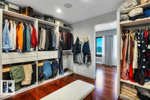 Custom closet system featuring multiple hanging rods, shelving, and pull-out drawers - 8914 120 Street, Edmonton, AB 