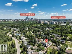 Aerial perspective of a residential neighborhood featuring mature trees and winding roads - 