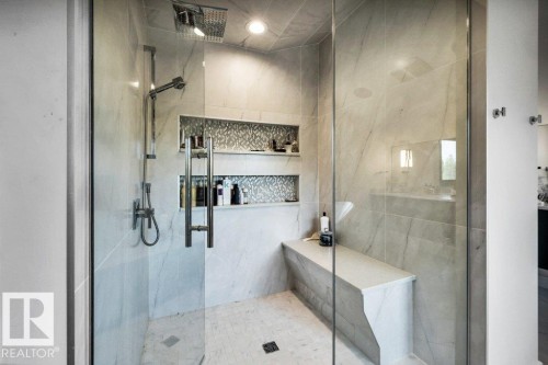 Spacious walk-in shower with a frameless glass enclosure, rain shower head, and an additional handheld shower fixture - 8914 120 Street, Edmonton, AB 