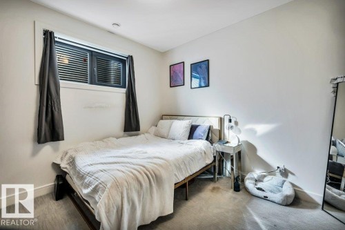 Bedroom featuring light-toned walls, recessed lighting, and grey carpet flooring - 8914 120 Street, Edmonton, AB 