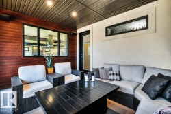 Covered patio with a slatted dark wood ceiling and recessed lighting - 