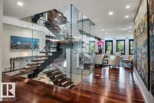 Floating wood-finish stairs with glass railings - 8914 120 Street, Edmonton, AB 