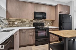 Kitchen featuring wood-finish cabinetry, white countertops, and a mosaic tile backsplash - 
