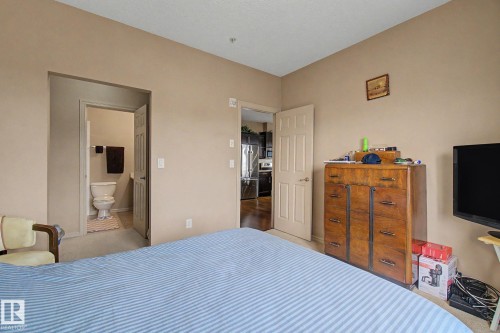 Bedroom with neutral wall tones and a cream-colored carpet - 415 263 Macewan Road, Edmonton, AB 