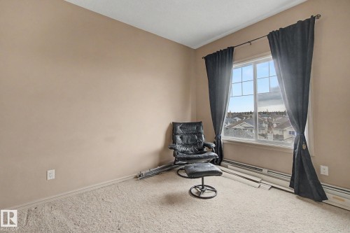 Neutral-toned walls complement the carpeted flooring - 415 263 Macewan Road, Edmonton, AB 