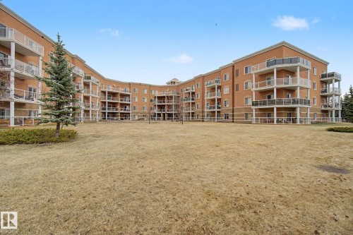 Multi-story building exterior featuring brick and stucco finishes - 415 263 Macewan Road, Edmonton, AB 