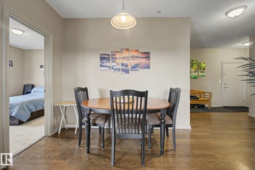 Open concept dining area featuring wood-finish flooring - 415 263 Macewan Road, Edmonton, AB 