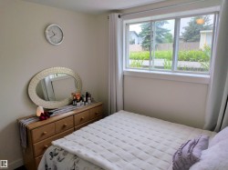 Room featuring a large window, light-colored walls, and a built-in window sill - 