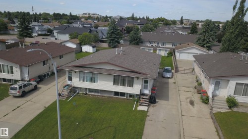 Single-story residence featuring light-colored siding, a dark shingle roof, and a mature green lawn - 31 Brown Street, Stony Plain, AB 