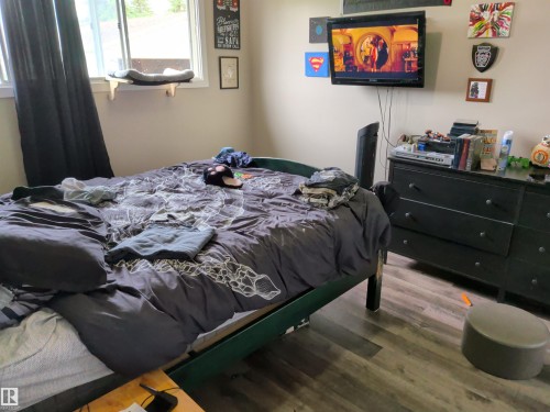 Bedroom featuring wood-finish flooring, a window with natural light, and neutral wall tones - 31 Brown Street, Stony Plain, AB 