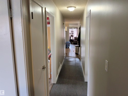 Hallway featuring neutral wall paint and a flush-mount ceiling light - 31 Brown Street, Stony Plain, AB 
