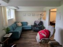 Living area with wood-finish flooring and a white ceiling - 31 Brown Street, Stony Plain, AB 